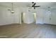 Inviting open-concept living room with modern light fixtures, neutral paint, and beautiful vinyl plank flooring at 4050 E Agave Rd, Phoenix, AZ 85044