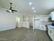 Bright kitchen with white cabinetry opens into a living area with light-colored, modern floors at 4050 E Agave Rd, Phoenix, AZ 85044