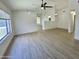 Bright and airy living room features modern ceiling fans, neutral paint, and beautiful vinyl plank flooring at 4050 E Agave Rd, Phoenix, AZ 85044