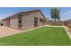 A good view of the backyard with turf and a stone perimeter at 41041 W Somers Dr, Maricopa, AZ 85138