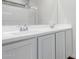 Bathroom featuring dual sinks, neutral paint, white cabinets, and tile flooring at 41041 W Somers Dr, Maricopa, AZ 85138