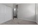 Carpeted bedroom with a closet with sliding doors, white walls and trim, and a window with natural light at 41041 W Somers Dr, Maricopa, AZ 85138