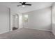 Bedroom featuring neutral carpet, a ceiling fan, and lots of natural light at 41041 W Somers Dr, Maricopa, AZ 85138