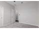 A light and bright bedroom featuring carpeted floor, white walls and trim, and a closet with doors at 41041 W Somers Dr, Maricopa, AZ 85138