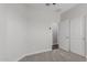 A light and bright bedroom featuring carpeted floor, white walls and trim, and a closet with sliding doors at 41041 W Somers Dr, Maricopa, AZ 85138