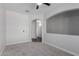 Bedroom featuring neutral carpet, ceiling fan, and arched doorway at 41041 W Somers Dr, Maricopa, AZ 85138