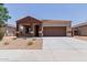Charming single-story home boasts a well-manicured front yard and a two car garage enhancing its curb appeal and convenience at 41041 W Somers Dr, Maricopa, AZ 85138