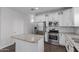 Bright kitchen with stainless steel appliances, granite counters and an island at 41041 W Somers Dr, Maricopa, AZ 85138