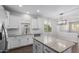 Kitchen featuring white cabinets, granite countertops, subway tile backsplash, and an island at 41041 W Somers Dr, Maricopa, AZ 85138