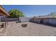 Landscaped backyard features gravel, a fire pit, and a storage shed at 450 N 110Th St, Mesa, AZ 85207