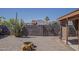 Backyard view with desert landscaping, cacti, brick wall, firepit and mountain views in the distance at 450 N 110Th St, Mesa, AZ 85207