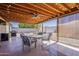 Covered backyard patio with outdoor seating, ceiling fan, and lighting, perfect for entertaining at 450 N 110Th St, Mesa, AZ 85207