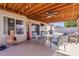 Covered backyard patio includes outdoor furniture, ceiling fan, and backyard view at 450 N 110Th St, Mesa, AZ 85207