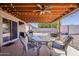 Covered patio featuring a dining table, seating area, outdoor grill, and a well-maintained yard at 450 N 110Th St, Mesa, AZ 85207
