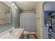 Well-lit bathroom featuring a vanity with a mirror and a shower with a patterned curtain at 450 N 110Th St, Mesa, AZ 85207