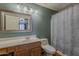 Well-lit bathroom with vanity, decorative mirror, and shower/tub combo with curtain at 450 N 110Th St, Mesa, AZ 85207