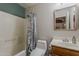 Bathroom features a tub with shower, decorative curtain, toilet, sink with wood vanity, and mirror at 450 N 110Th St, Mesa, AZ 85207