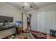 Versatile bedroom space with ceiling fan, closet, and wood flooring at 450 N 110Th St, Mesa, AZ 85207