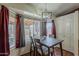 Dining room showcasing a stylish table setting, natural light from the bay window and hardwood floors at 450 N 110Th St, Mesa, AZ 85207