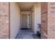 The house has a charming entryway with brick pillars and a screen door for added security at 450 N 110Th St, Mesa, AZ 85207
