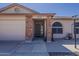 This beautiful home has a charming brick entryway and a well-manicured, desert-style front yard at 450 N 110Th St, Mesa, AZ 85207