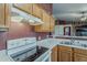 This kitchen features light wood cabinets, white countertops, and essential appliances for a cozy cooking space at 450 N 110Th St, Mesa, AZ 85207