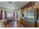Bright kitchen features a large stainless steel refrigerator and a cozy dining area near the window at 450 N 110Th St, Mesa, AZ 85207