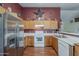 This kitchen has stainless steel appliances, wood cabinets, and solid surface countertops at 450 N 110Th St, Mesa, AZ 85207