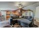 Open concept living room with wood floors, a sectional sofa, and seamless access to the kitchen area at 450 N 110Th St, Mesa, AZ 85207