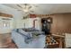 Spacious living room offers a comfortable sectional sofa, mounted TV, wood floors and a cozy atmosphere at 450 N 110Th St, Mesa, AZ 85207