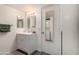 Well-lit bathroom featuring a vanity with a framed mirror and a stacked washer dryer at 461 W Holmes Ave # 350, Mesa, AZ 85210