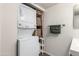 Functional laundry area combined with bathroom showcasing stacked washer/dryer and shelving at 461 W Holmes Ave # 350, Mesa, AZ 85210