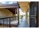Hallway with a black metal railing and black metal security doors, with a glimpse of greenery in the distance at 461 W Holmes Ave # 350, Mesa, AZ 85210