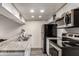 Galley kitchen featuring stainless steel appliances and speckled granite countertops at 461 W Holmes Ave # 350, Mesa, AZ 85210