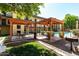 Outdoor patio with picnic tables, gravel, a small patch of grass and an apartment complex in the background at 461 W Holmes Ave # 350, Mesa, AZ 85210