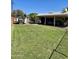 Expansive backyard featuring a lush lawn, covered patio, and ample space for outdoor activities and recreation at 4814 N 35Th St, Phoenix, AZ 85018