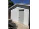 A stand-alone white storage building with a gray door next to the house at 4814 N 35Th St, Phoenix, AZ 85018