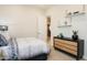 Comfortable bedroom featuring a patterned comforter, and a black mid-century modern dresser with decorative shelving at 4941 W Capistrano Ave, Laveen, AZ 85339
