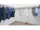Walk-in closet with hanging shirts, offering storage and organization in a clean and efficient design at 4941 W Capistrano Ave, Laveen, AZ 85339