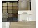 A selection of interior design options featuring carpet, cabinets, kitchen backsplash, and a white sand quartz countertop at 4941 W Capistrano Ave, Laveen, AZ 85339