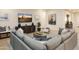 Comfortable living room with a gray sectional sofa, modern decor, and a media console with a TV at 4941 W Capistrano Ave, Laveen, AZ 85339