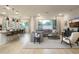 Bright and open living room featuring a large sectional sofa, hardwood floors, and a view of the dining area at 4941 W Capistrano Ave, Laveen, AZ 85339