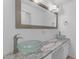 Bathroom with double glass bowl sinks, framed mirror and marble countertop with white cabinets at 527 N Lesueur --, Mesa, AZ 85203