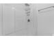 Shower with white tile walls, shower head, and a metal shower rack at 527 N Lesueur --, Mesa, AZ 85203