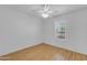 Bedroom with wood floors and white walls, featuring a ceiling fan and natural light at 527 N Lesueur --, Mesa, AZ 85203