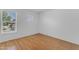 Bright bedroom with wood floors, white walls, and a window providing natural light at 527 N Lesueur --, Mesa, AZ 85203