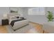 Cozy bedroom with wood floors, a tufted headboard, and a large window for natural light at 527 N Lesueur --, Mesa, AZ 85203