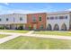 View of townhouses with green lawns, sidewalks, and unique architectural designs at 527 N Lesueur --, Mesa, AZ 85203