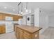 Spacious kitchen with wood cabinets, an island, and modern appliances at 527 N Lesueur --, Mesa, AZ 85203