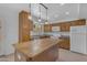 Inviting kitchen with wood cabinets, a central island, and ample counter space at 527 N Lesueur --, Mesa, AZ 85203